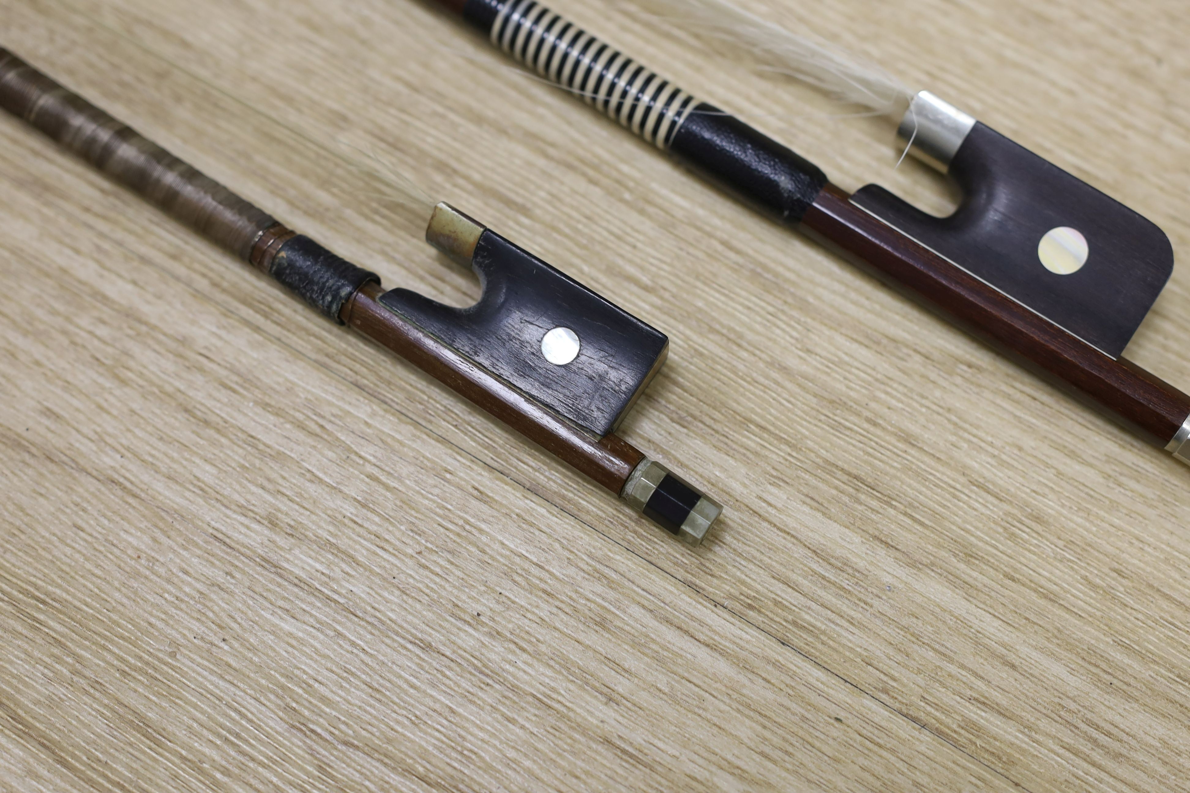 Two violin bows, signed Erich Steiner and Tourte, 73 cms long.